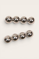 Two metallic silver ball-barre hair clips with five reflective spheres each, displayed on a light cream background.