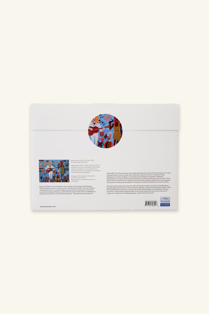 Back cover of packaging for a colorful tea towel with art by Kaylene Whiskey, featuring illustrations of Dolly Parton and Tina Turner