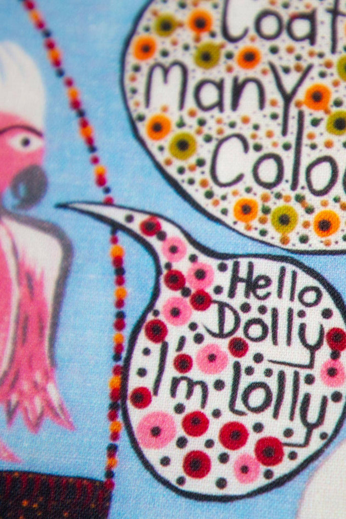 Close up of olorful tea towel with art by Kaylene Whiskey, featuring the text "Hello Dolly, I'm Lolly"